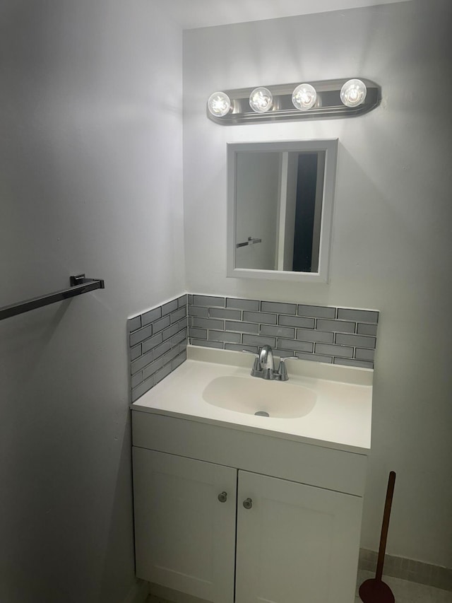 bathroom featuring vanity and tasteful backsplash