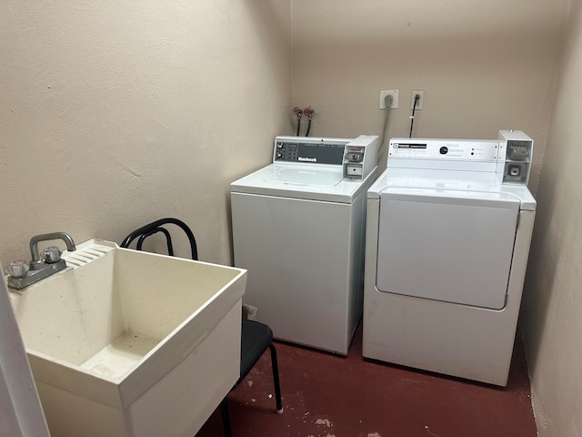 laundry area featuring sink and separate washer and dryer