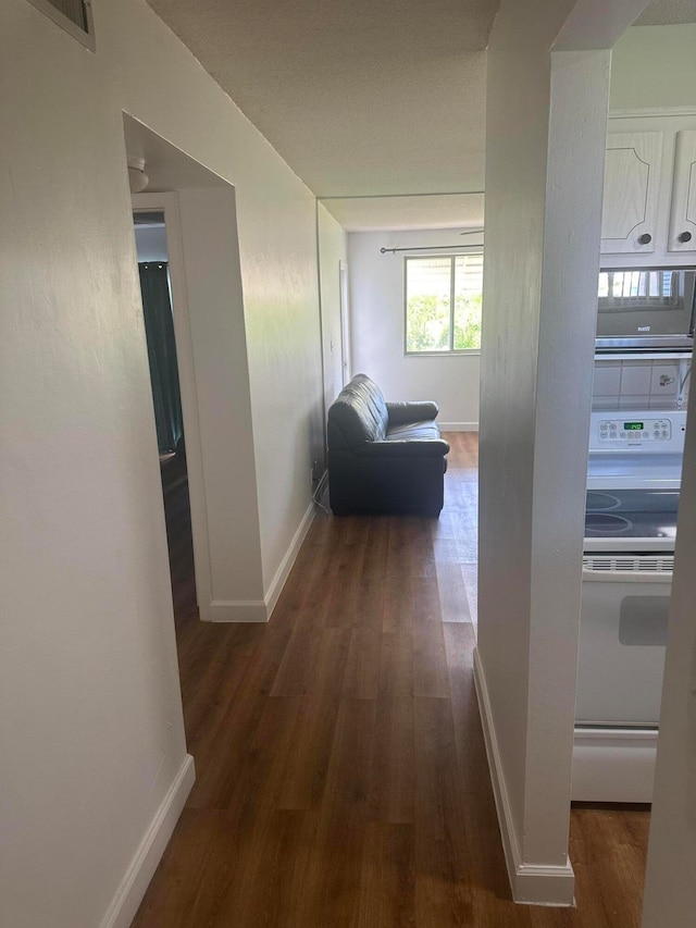 hall with dark wood-type flooring