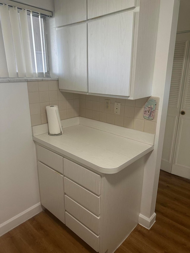 bathroom featuring backsplash and wood-type flooring