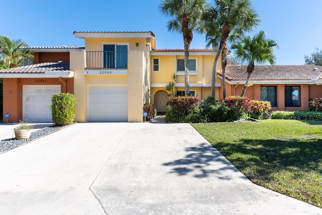 view of front of property with a front yard and a garage