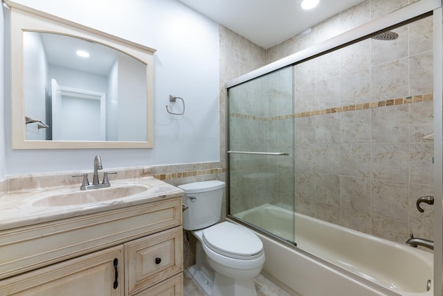 full bathroom featuring vanity, tile walls, toilet, and combined bath / shower with glass door