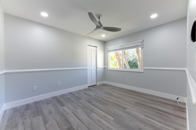 spare room featuring light wood-type flooring and ceiling fan