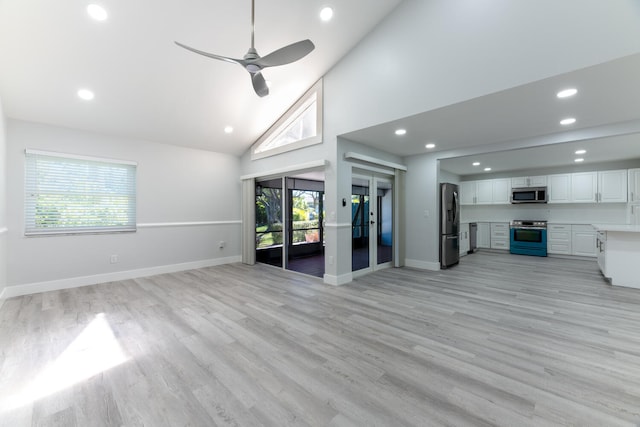 unfurnished living room with ceiling fan, light hardwood / wood-style flooring, high vaulted ceiling, and a wealth of natural light