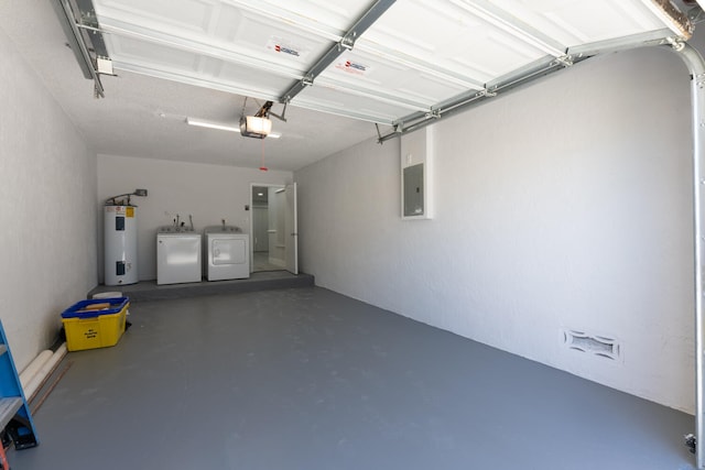 garage featuring a garage door opener, electric panel, washer and clothes dryer, and electric water heater