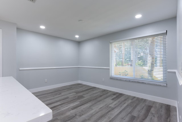 unfurnished room featuring dark hardwood / wood-style flooring