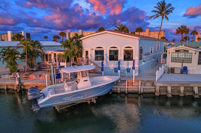 back house at dusk with a water view