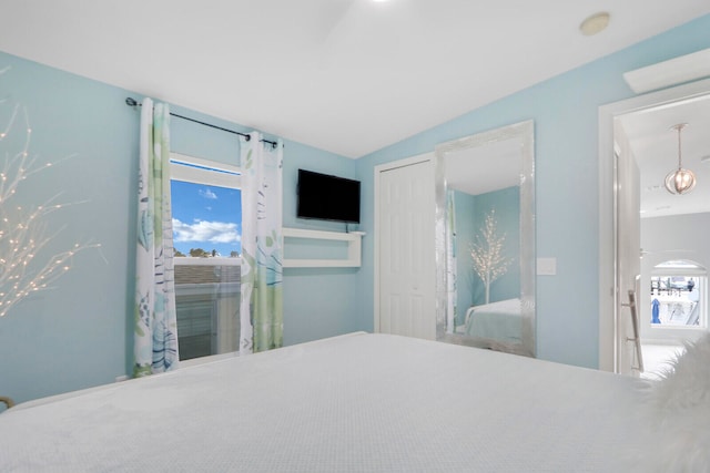 carpeted bedroom with vaulted ceiling