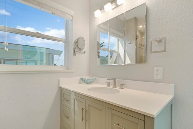 bathroom featuring a wealth of natural light and vanity