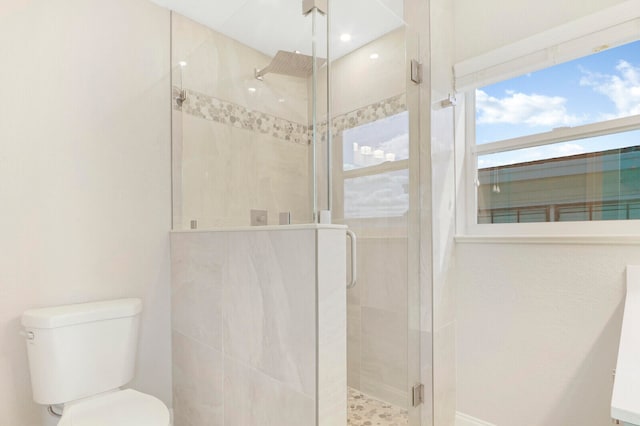 bathroom with toilet and walk in shower