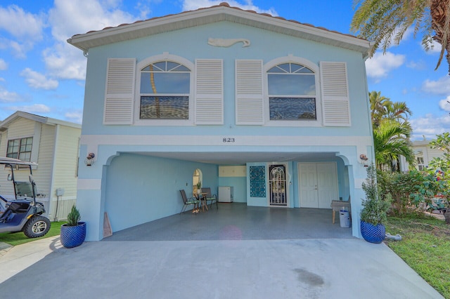 view of front of home featuring a garage and a carport