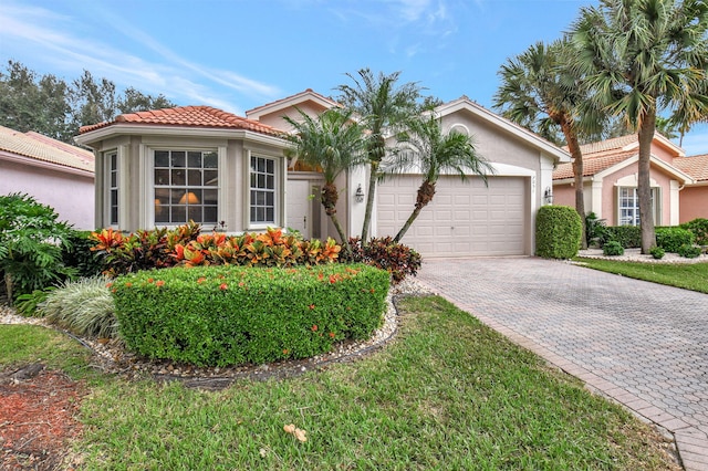 view of front of house featuring a front yard and a garage