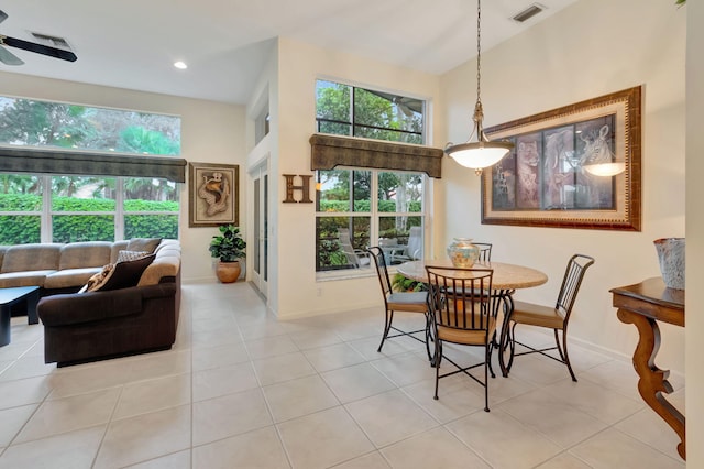 dining space featuring ceiling fan and light tile patterned floors