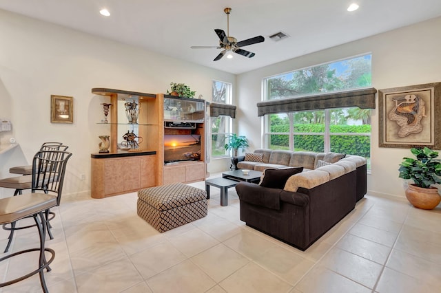 tiled living room with ceiling fan