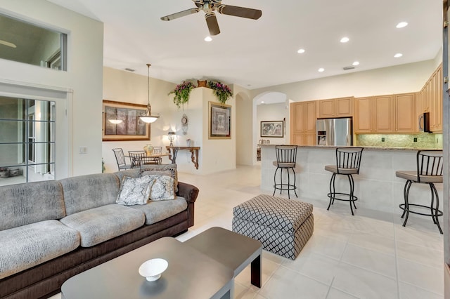 tiled living room featuring ceiling fan