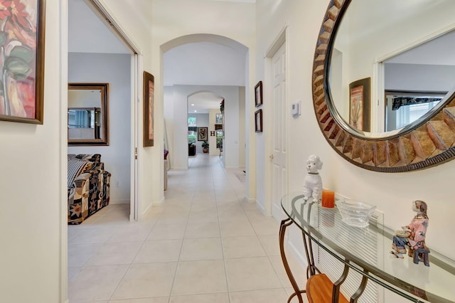 hall with a healthy amount of sunlight and light tile patterned flooring