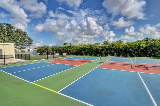 view of tennis court with basketball hoop