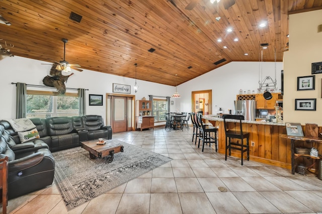 living room with ceiling fan, plenty of natural light, and high vaulted ceiling