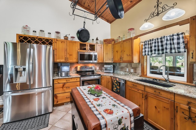 kitchen featuring pendant lighting, wooden ceiling, sink, light stone countertops, and stainless steel appliances