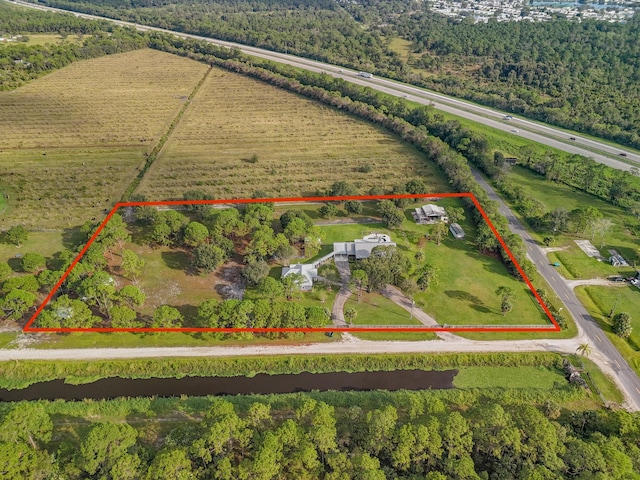 birds eye view of property featuring a rural view