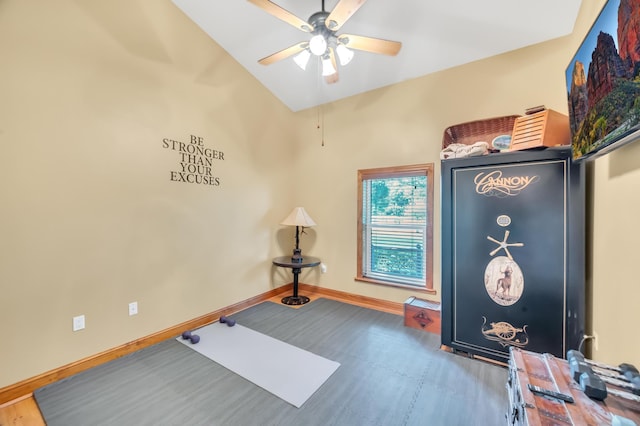 exercise room featuring hardwood / wood-style floors, vaulted ceiling, and ceiling fan