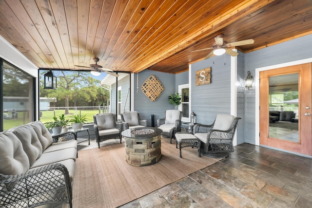 sunroom / solarium with beam ceiling, ceiling fan, and wooden ceiling