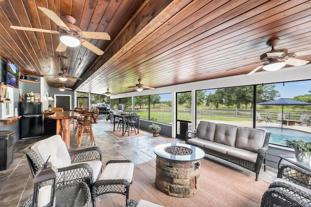 sunroom featuring wooden ceiling and lofted ceiling