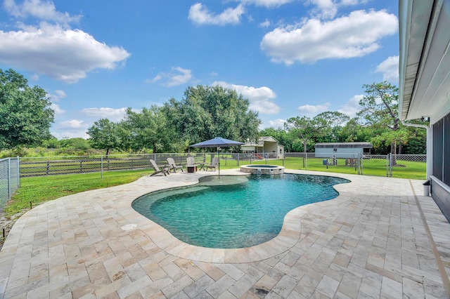 view of pool featuring a lawn, an in ground hot tub, and a patio