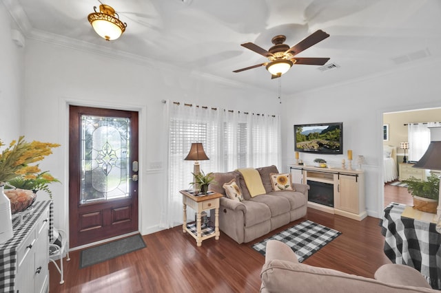 living room featuring ceiling fan, dark hardwood / wood-style flooring, and ornamental molding