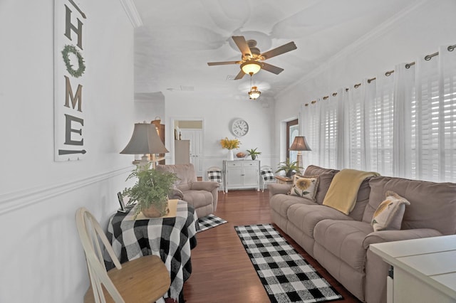 living room with dark hardwood / wood-style floors, ceiling fan, and crown molding