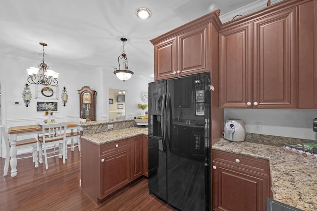 kitchen featuring pendant lighting, dark hardwood / wood-style floors, black fridge with ice dispenser, and ornamental molding