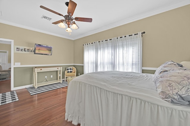 bedroom with hardwood / wood-style flooring, ceiling fan, and crown molding