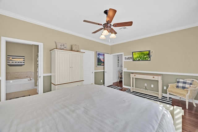 bedroom with ceiling fan, crown molding, ensuite bathroom, and dark wood-type flooring