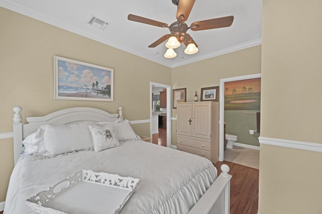 bedroom featuring hardwood / wood-style flooring, ensuite bath, ceiling fan, and crown molding