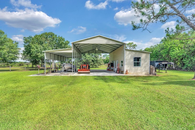 back of house featuring a carport and a lawn