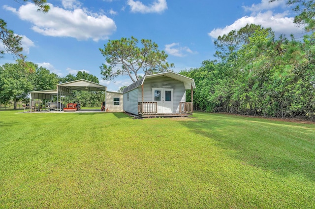 back of house with a carport and a yard