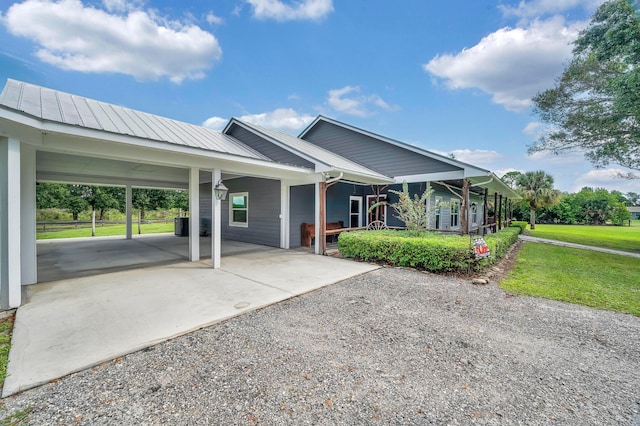 view of front facade with a front yard and a carport