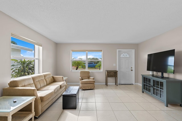 tiled living room featuring plenty of natural light and a textured ceiling