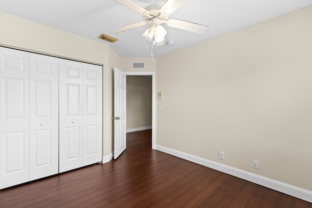 unfurnished bedroom featuring a closet, ceiling fan, and dark wood-type flooring