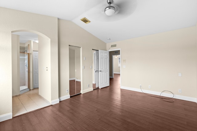 unfurnished bedroom featuring ceiling fan, wood-type flooring, and vaulted ceiling