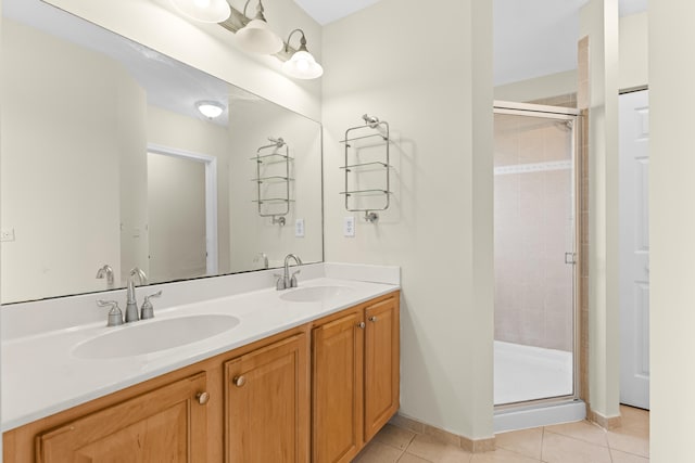 bathroom featuring tile patterned flooring, vanity, and a shower with shower door