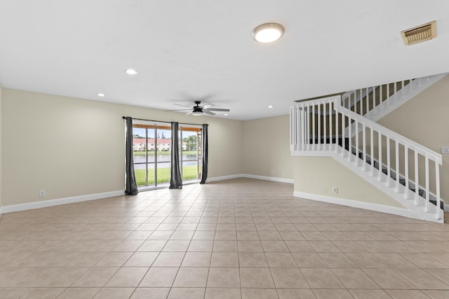 unfurnished room with light tile patterned floors and ceiling fan