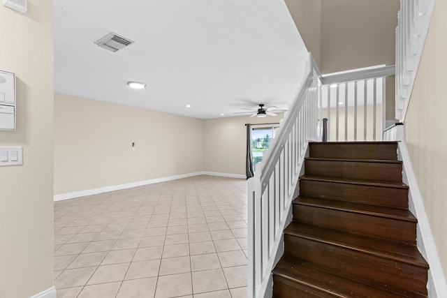 staircase with tile patterned flooring and ceiling fan