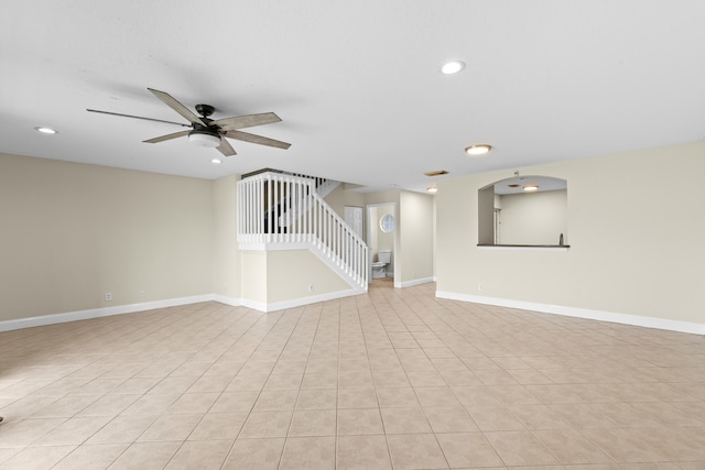 unfurnished living room featuring ceiling fan and light tile patterned floors