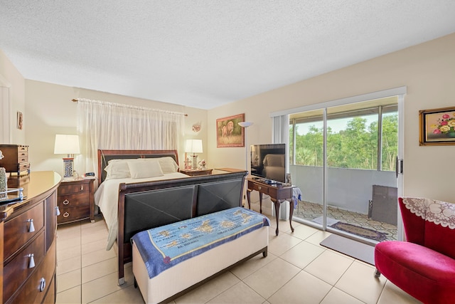 tiled bedroom with access to outside and a textured ceiling