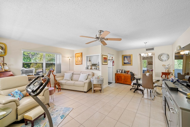 living room with a textured ceiling, ceiling fan with notable chandelier, and light tile patterned floors