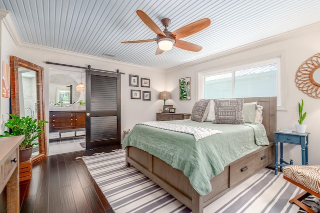 bedroom with dark wood-type flooring, wood ceiling, a barn door, and ceiling fan