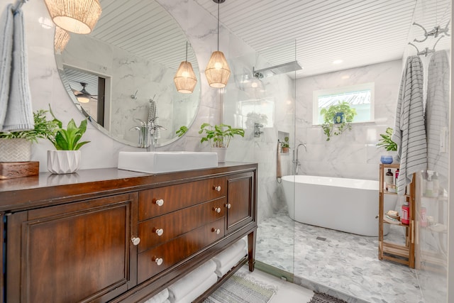 bathroom with ceiling fan, vanity, tile walls, and separate shower and tub