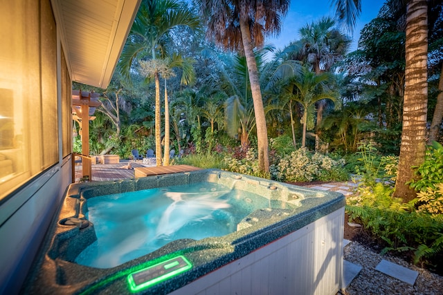 view of swimming pool with a hot tub