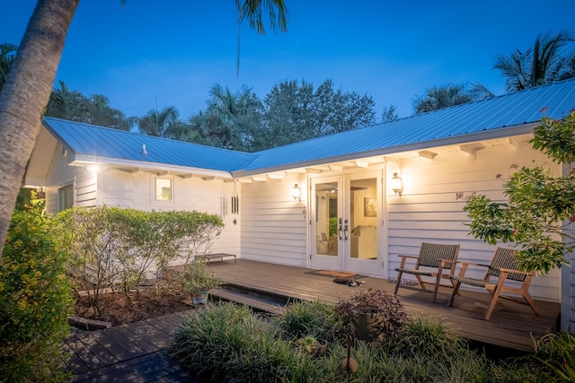 rear view of house featuring french doors and a wooden deck